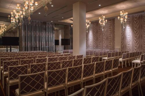 an empty room with rows of chairs and chandeliers at Kimpton Hotel Monaco Philadelphia by IHG in Philadelphia