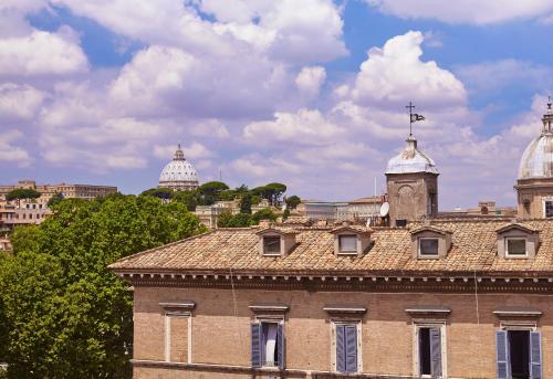 a building with a clock tower on top of it at Hotel Indigo Rome - St. George by IHG in Rome