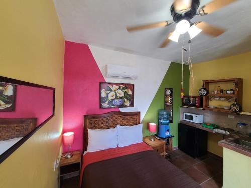 a bedroom with a bed with a colorful wall at Suites de Mita - Boutique Hotel in Punta Mita
