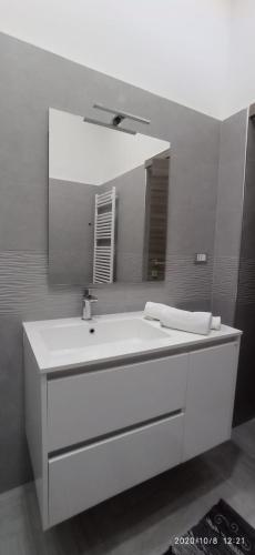 a bathroom with a white sink and a mirror at Mary’s House in Torre del Greco