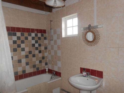 a bathroom with a sink and a toilet and a tub at 14 rue de Monteville in Coupelle-Vieille