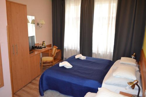 Postel nebo postele na pokoji v ubytování Aladin Praha