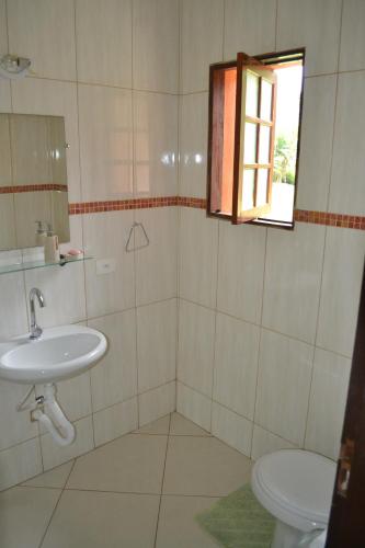 a bathroom with a sink and a toilet at Tropical Paradise in Ubatuba