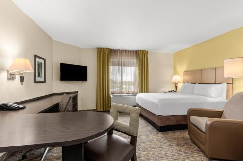 a hotel room with a bed and a table at Candlewood Suites - Fairbanks by IHG in Fairbanks