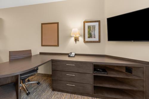 a room with a desk with a tv and a desk sidx sidx sidx at Candlewood Suites - Fairbanks by IHG in Fairbanks