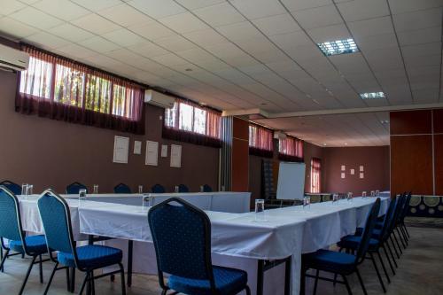 a long table and chairs in a room at MalVille Boutique Hotel in Lilongwe