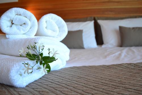 a hotel room with towels on a bed at Hjem Studios in La Pedrera