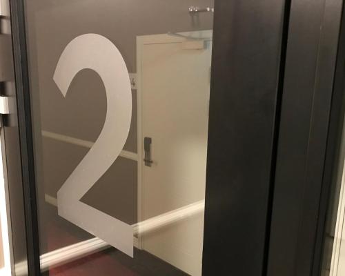 a glass door with a white number on it at Best Western Hotel Savoy in Karlstad