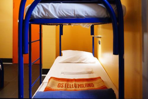 a bunk bed with a sign on the bottom bunk at Hi! Ostello Milano in Milan