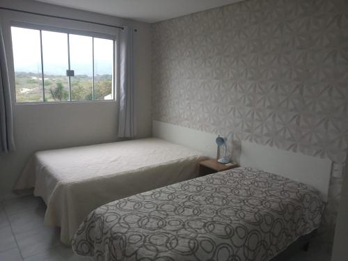 Łóżko lub łóżka w pokoju w obiekcie Residencial Mariano 4 - Vista para praia e Mar