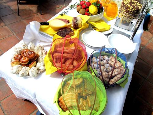 a table with many different types of food on it at Hotel Pop in Cala Gonone