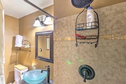 a bathroom with a sink and a toilet and a mirror at Rustic-Yet-Cozy Cabin with Patio, 12 Mi to Asheville in Arden