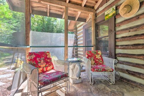 two chairs and a table on the porch of a cabin at Rustic-Yet-Cozy Cabin with Patio, 12 Mi to Asheville in Arden