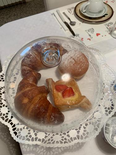 a plate of pastries and bread on a table at B&B Amy&Julie in Badia Polesine