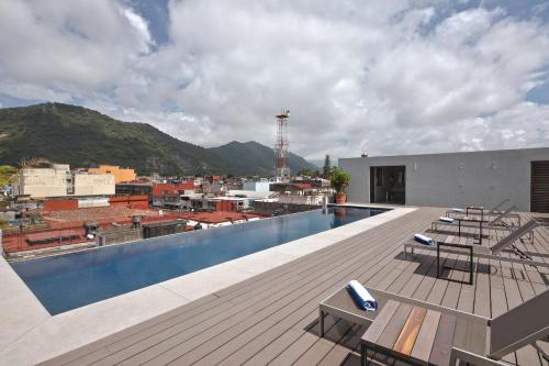 a swimming pool on the roof of a building at Gamma Orizaba Grand Hotel de France in Orizaba