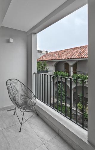 a chair sitting on the balcony of a building at Gamma Orizaba Grand Hotel de France in Orizaba