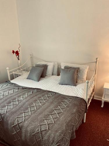 un letto bianco con cuscini sopra di Beautiful 2 bedroom flat in Camden a Londra