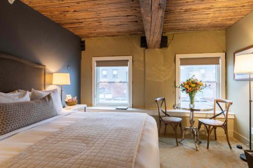 a bedroom with a large bed and a table with chairs at Inn at Lynden in Lynden
