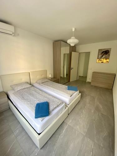 a bedroom with two beds in a room at Appartamento Lungolago in Locarno