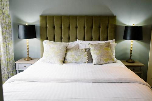 a bedroom with a large bed with pillows and two lamps at Prince of Wales - Townhouse in London
