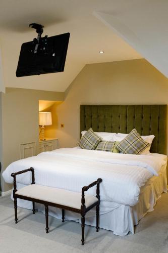 a bedroom with a large white bed and a tv at Prince of Wales - Townhouse in London