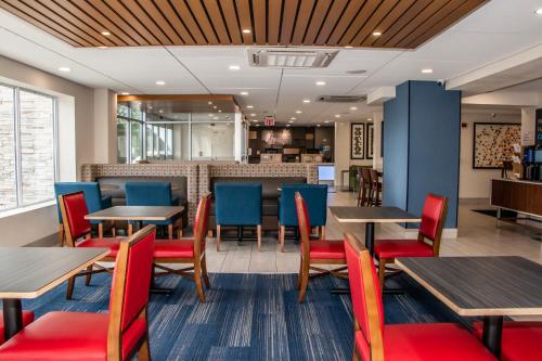 a dining room with tables and blue chairs at Holiday Inn Express - Allentown North by IHG in Allentown