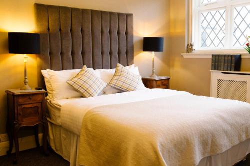 a bedroom with a large white bed with two lamps at Prince of Wales - Townhouse in London