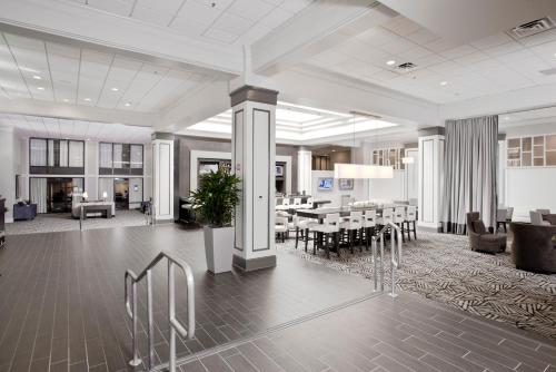 a dining room and living room with a table and chairs at Crowne Plaza Greenville by IHG in Greenville