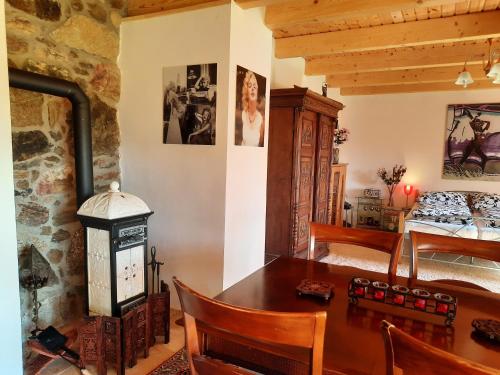 a dining room with a table and a bedroom at Novohradské hory - pronájem na samotě u lesa in Benešov nad Černou