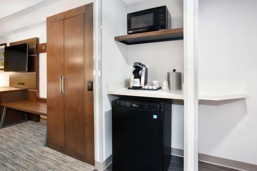 a kitchen with a black dishwasher and a microwave at Holiday Inn Express Exton - Great Valley by IHG in Exton