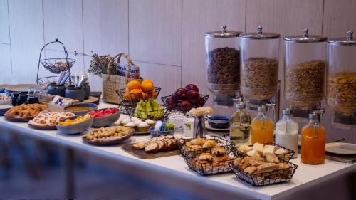 a table with many baskets of food and bottles at Holiday Inn Express Hyderabad Banjara Hills by IHG in Hyderabad