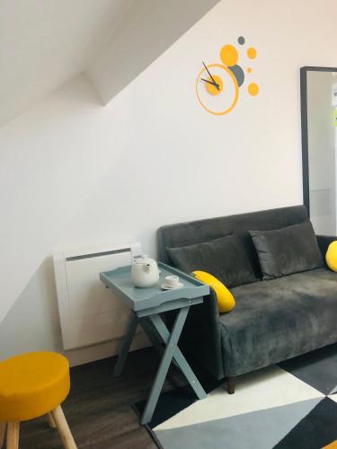 a living room with a couch and a table at ★Le Petit Cosy Vincennes★ in Vincennes