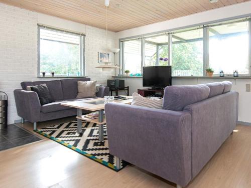 a living room with two couches and a table at 7 person holiday home in Knebel in Knebel