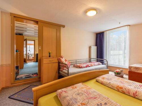 a hotel room with two beds and a mirror at Schönes Ferienhaus in Biendorf mit Garten in Körchow