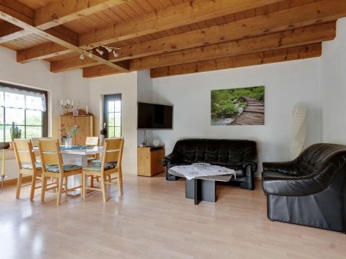 a living room with a couch and a table at Cosy holiday home in Olsberg with garden in Olsberg