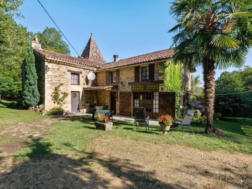 Villefranche-du-PérigordにあるCosy holiday home with gardenのヤシの木が目の前にある家