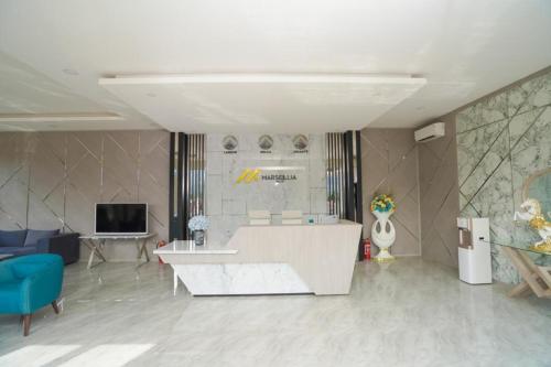 a living room with a couch and a table at Marseillia Hills in Puncak