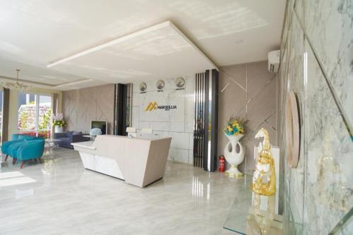 a lobby with a reception desk in a building at Marseillia Hills in Puncak