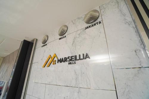 a marble wall with the logo of a maselka files at Marseillia Hills in Puncak