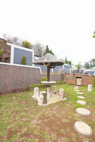 a park with a picnic table and an umbrella at Marseillia Hills in Puncak