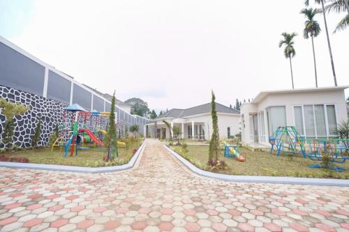 a playground in front of a building with a playground at Marseillia Hills in Puncak