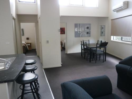 a dining room with a table and chairs at Sovereign Views Apartments in Ballarat