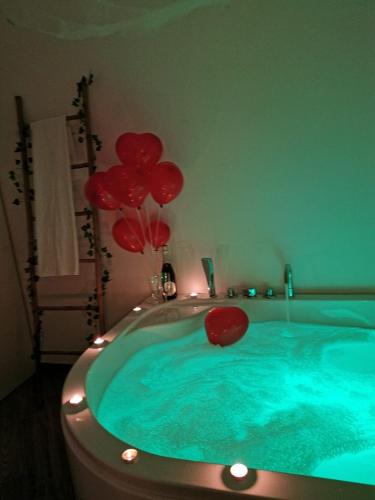 a hot tub with red balloons in a room at Sea fly guest house in Fiumicino