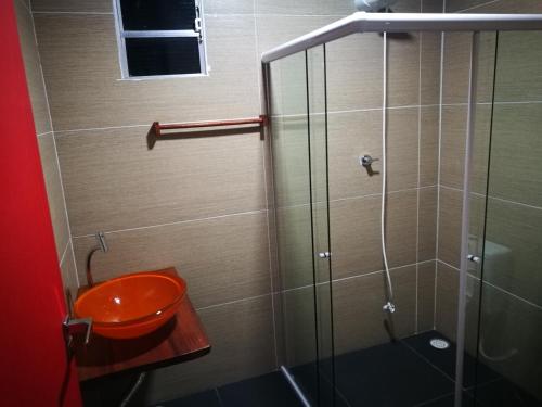 a bathroom with a toilet and a glass shower at Zen Spa Houses in São Miguel dos Milagres