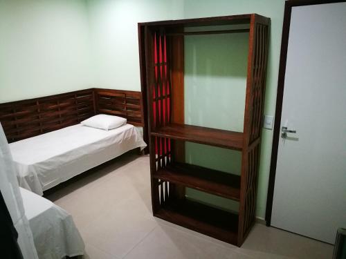 a room with a bedroom with a mirror and a bed at Zen Spa Houses in São Miguel dos Milagres