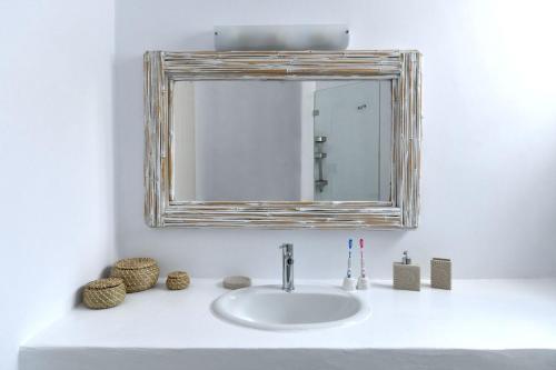 a bathroom sink with a mirror on a white counter at Luxury Paros Villa Villa Aethra Beautiful Serene Glisidia in Kampos Paros