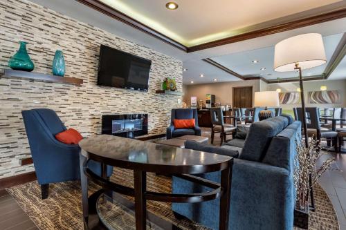 a living room with a couch and chairs and a table at Comfort Inn & Suites Butler in Butler