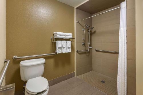 a bathroom with a toilet and a shower at Comfort Suites The Villages in The Villages