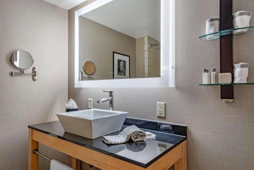 a bathroom with a sink and a mirror at Cambria Hotel Columbus - Polaris in Columbus