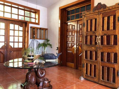 a room with wooden doors and a glass table at Casa de la Aduana Hotel Boutique in Topolobampo